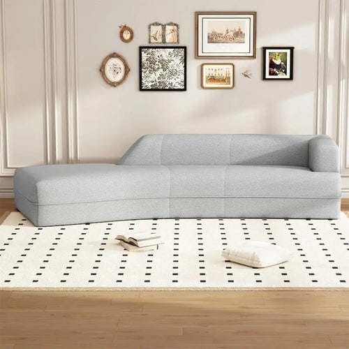 Divano curvo a chaise longue in tessuto bouclé